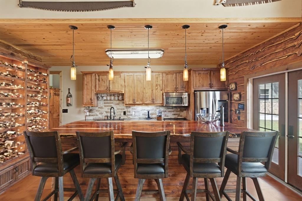 722 3 Skillet Road Springtown, TX 76082 - Photo 14 of 40 a dining hall with stainless steel appliances a dining table and chairs with wooden floor