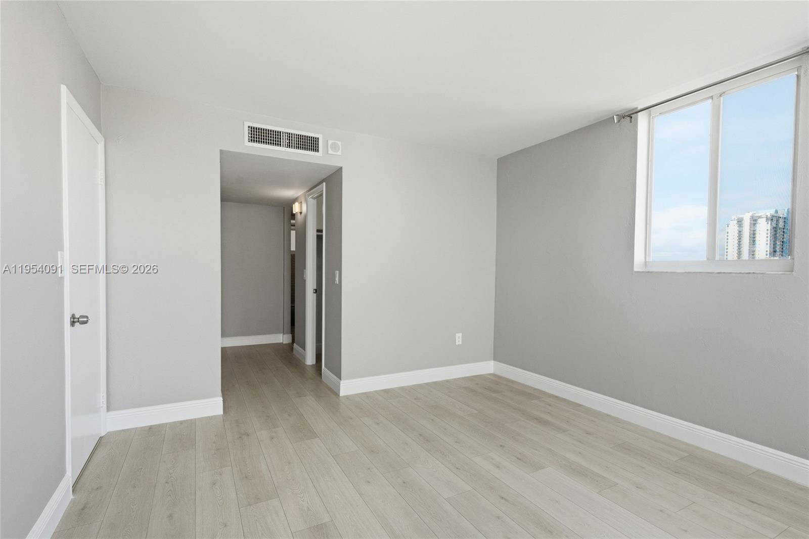 1345 Lincoln Road, Unit 1006 Miami Beach, FL 33139 - Photo 13 of 27 an empty room with wooden floor closet and windows