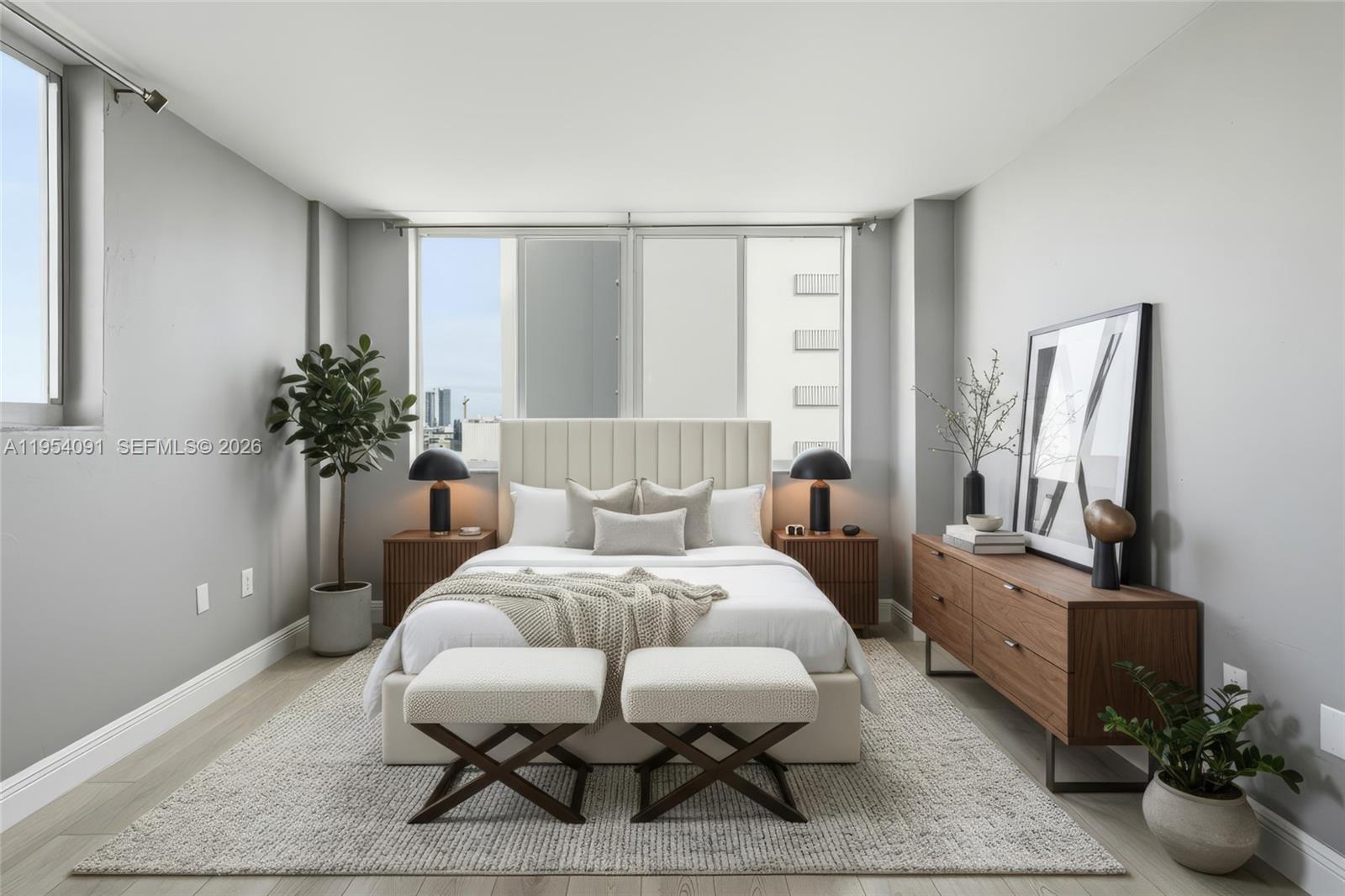 1345 Lincoln Road, Unit 1006 Miami Beach, FL 33139 - Photo 2 of 27 a bedroom with furniture and a potted plant