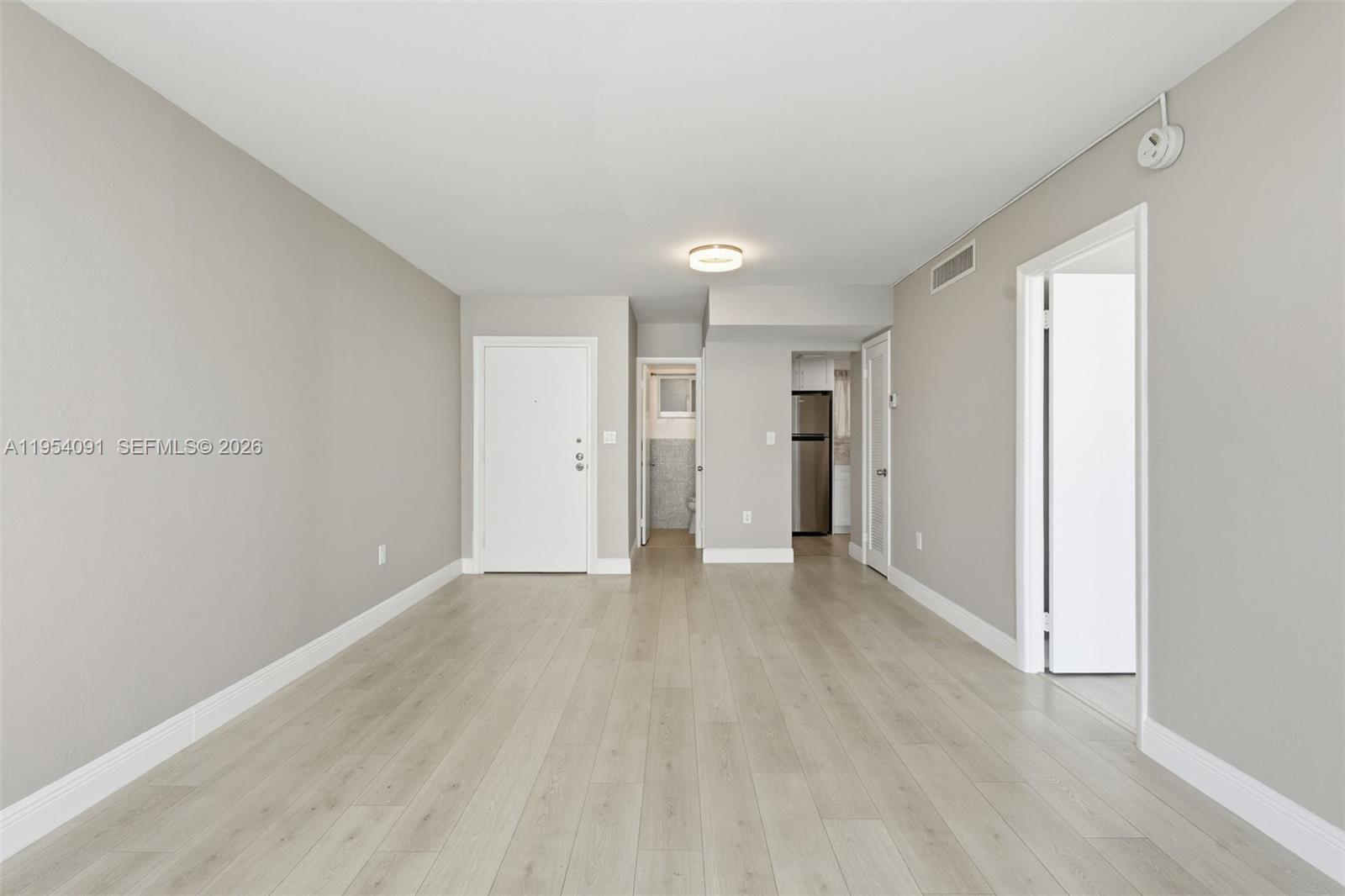 1345 Lincoln Road, Unit 1006 Miami Beach, FL 33139 - Photo 4 of 27 a view of an empty room with wooden floor