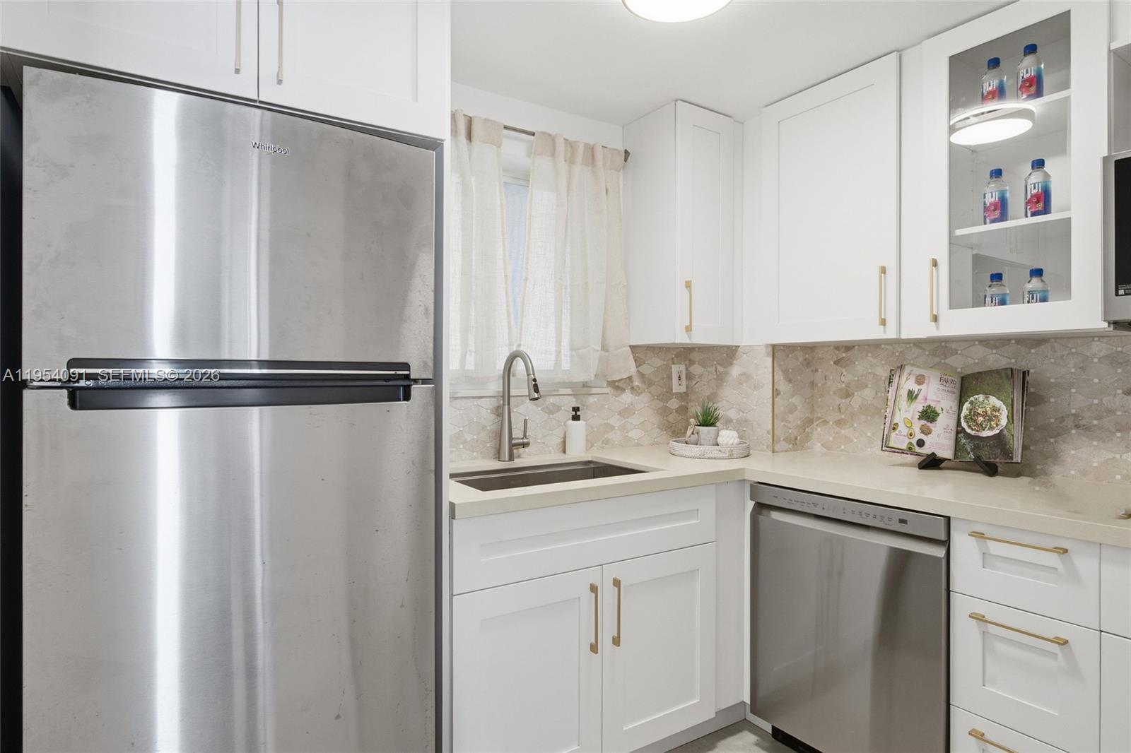 1345 Lincoln Road, Unit 1006 Miami Beach, FL 33139 - Photo 5 of 27 a kitchen with a refrigerator and sink