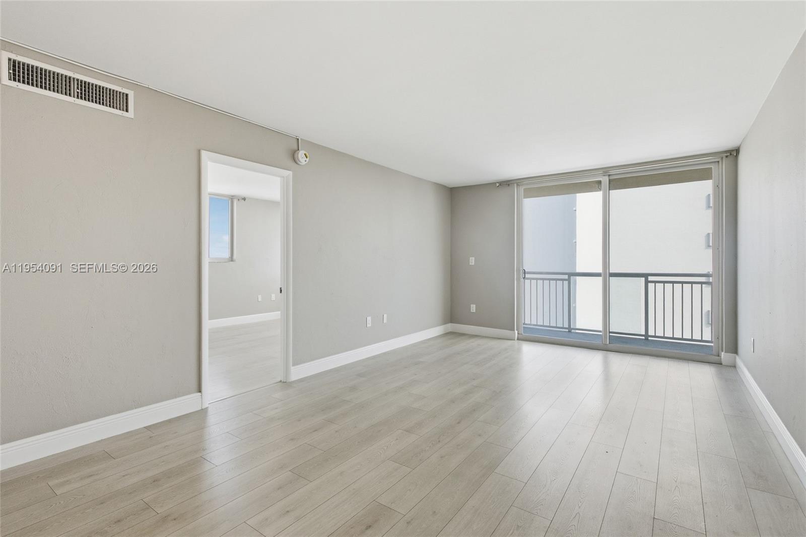 1345 Lincoln Road, Unit 1006 Miami Beach, FL 33139 - Photo 7 of 27 wooden floor in an empty room with a window