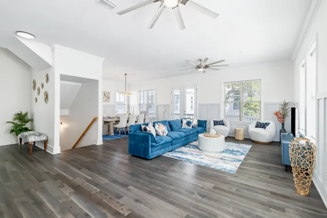 a living room with furniture and wooden floor