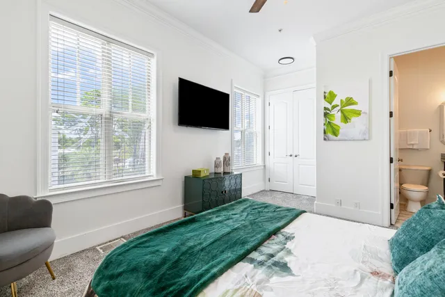 a spacious bedroom with a bed and a chandelier