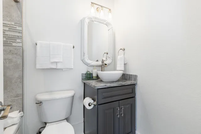 a white couch sitting in a living room next to a window