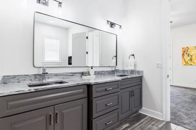 a front view of a house with a yard and potted plants