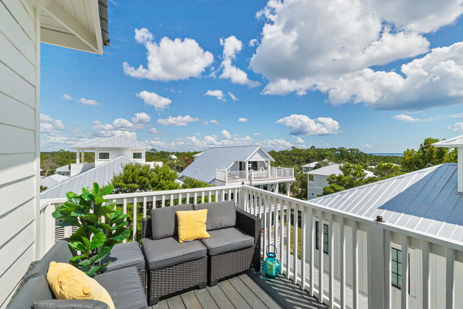 337 Grande Pointe Circle Inlet Beach, FL 32461 - Photo 53 of 73 a view of a balcony with two chairs potted plants with wooden fence