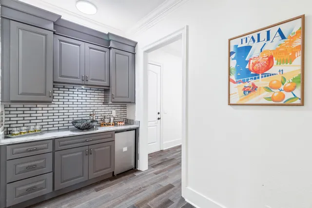 a bathroom with a granite countertop bathtub shower sink vanity and toilet