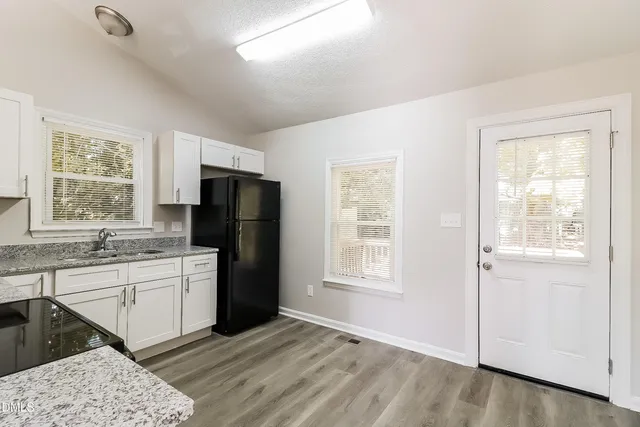 a kitchen with a refrigerator and a sink