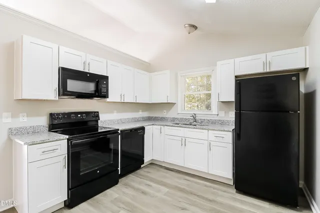 a kitchen with a sink stove and refrigerator