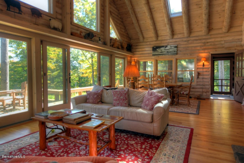 26 Mc Carthy Road Tyringham, MA 01264 - Photo 13 of 31 a living room with furniture a wooden floor and a large window