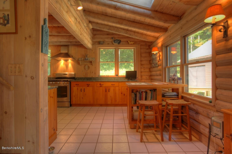 26 Mc Carthy Road Tyringham, MA 01264 - Photo 21 of 31 a view of a kitchen with granite countertop a dining table chairs and granite counter tops
