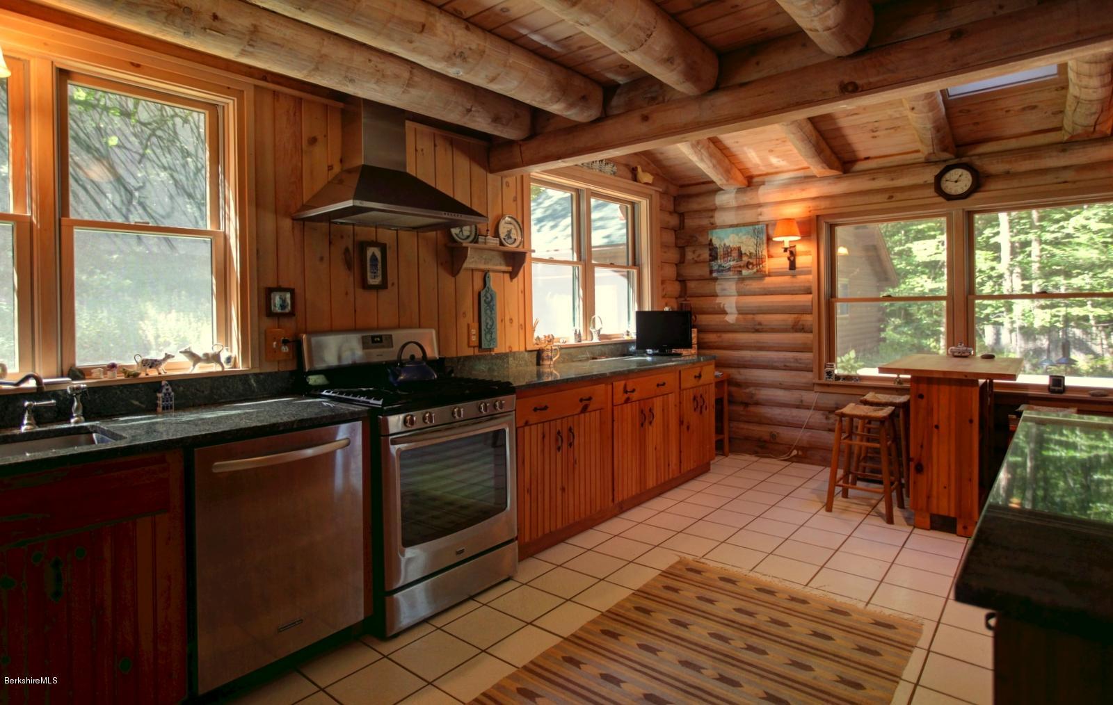 26 Mc Carthy Road Tyringham, MA 01264 - Photo 23 of 31 a kitchen with stainless steel appliances wooden cabinets a sink and a stove