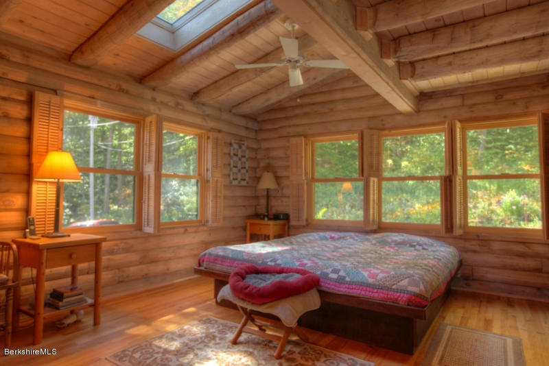 26 Mc Carthy Road Tyringham, MA 01264 - Photo 24 of 31 a bed sitting in a bedroom next to a window
