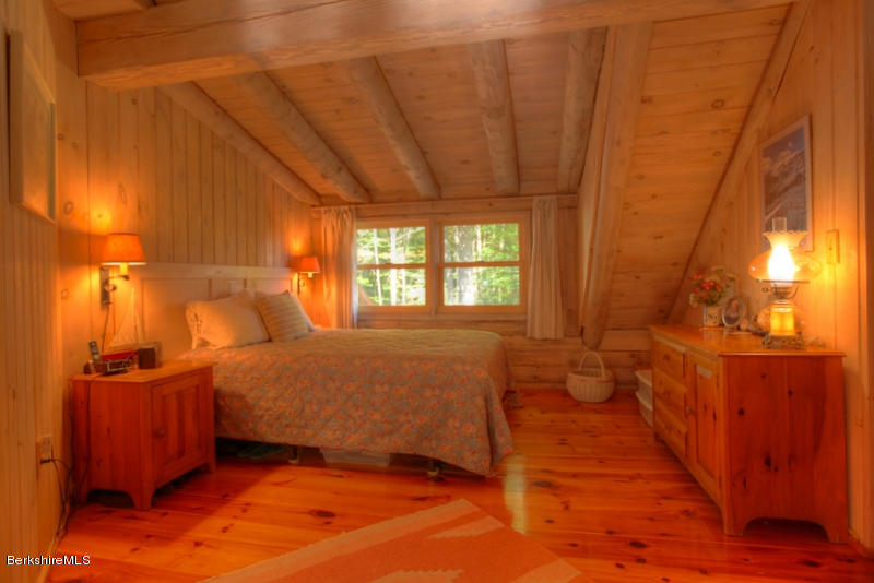 26 Mc Carthy Road Tyringham, MA 01264 - Photo 29 of 31 a bedroom with a bed and wooden floor