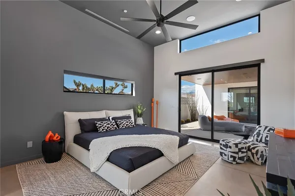 a bedroom with a large bed and a couch