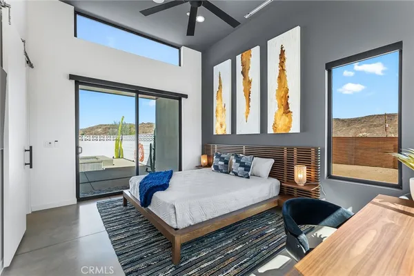 a bedroom with furniture and large window