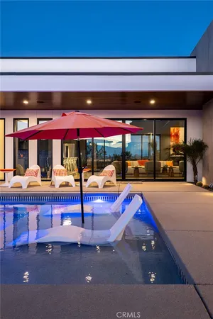 a backyard of a house with table and chairs