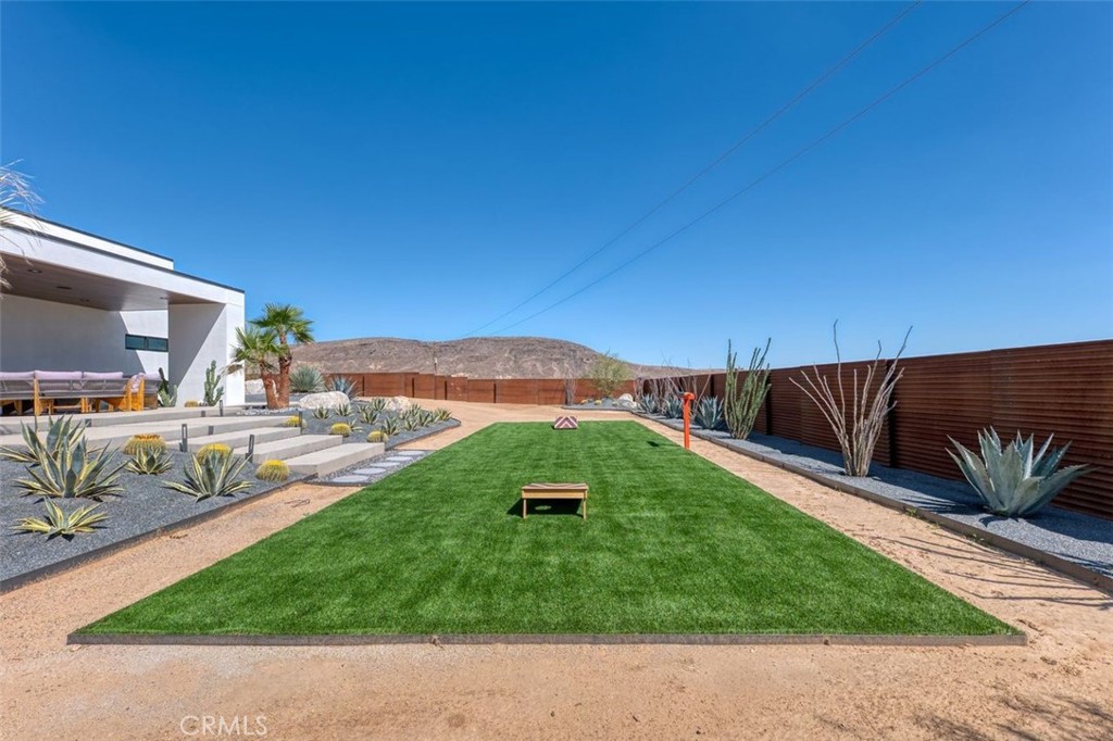 5165 Roy Rogers Road Pioneertown, CA 92268 - Photo 55 of 64 a backyard of a house with table and chairs
