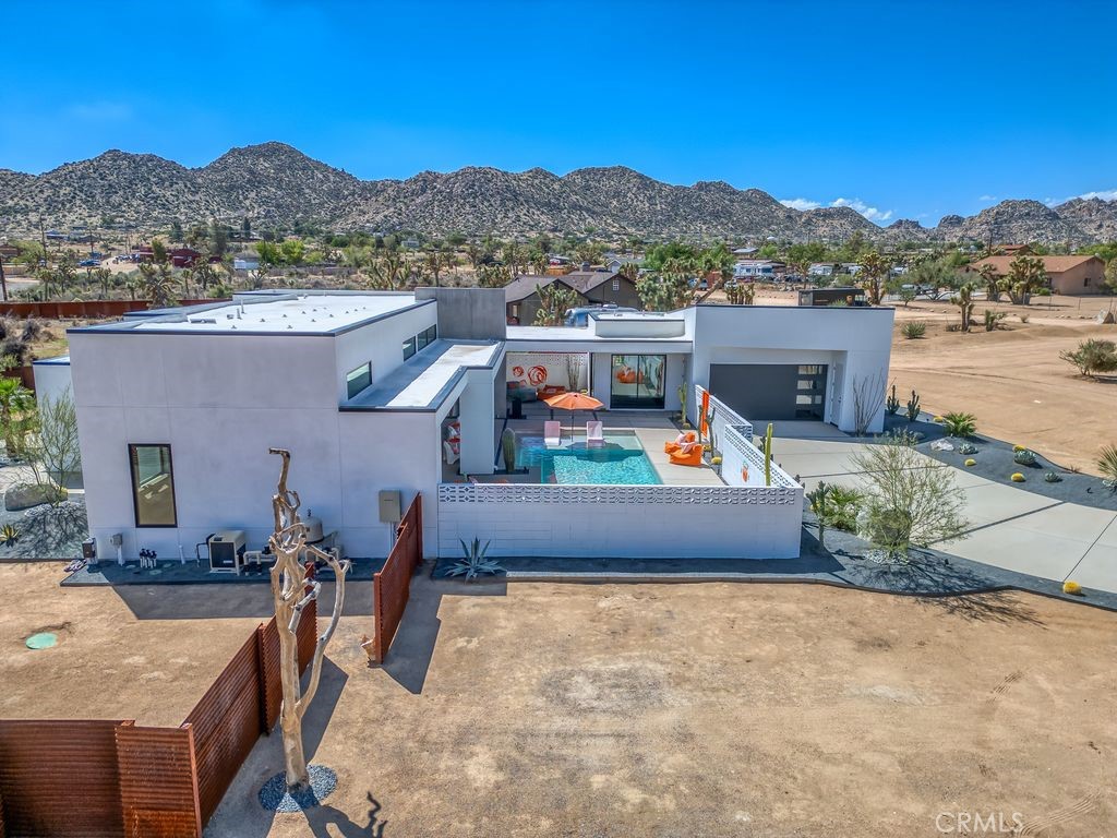 5165 Roy Rogers Road Pioneertown, CA 92268 - Photo 63 of 64 an aerial view of a house with a swimming pool a patio with dining table and chairs