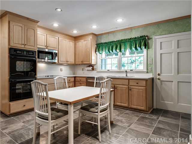 2935 Wheelock Road Charlotte, NC 28211 - Photo 7 of 16 a kitchen with granite countertop a stove a sink and a refrigerator