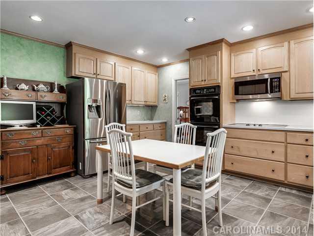 2935 Wheelock Road Charlotte, NC 28211 - Photo 8 of 16 a kitchen with stainless steel appliances kitchen island granite countertop a refrigerator and microwave