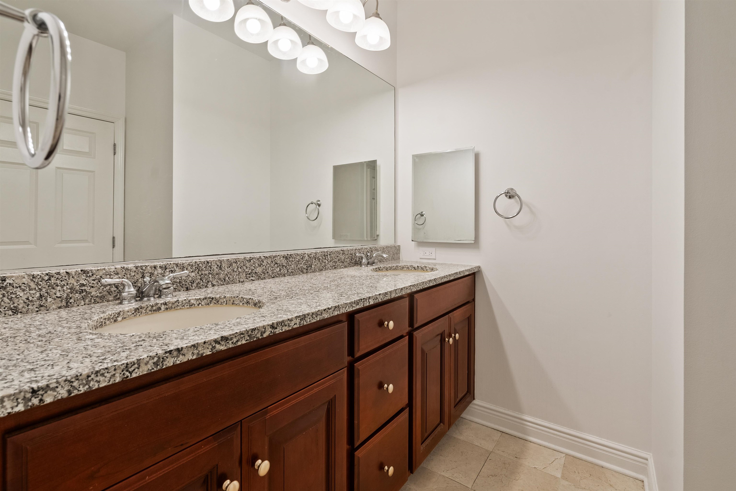 7400 River Road, Unit 317 North Bergen, NJ 07047 - Photo 16 of 41 a bathroom with a granite countertop sink and a mirror