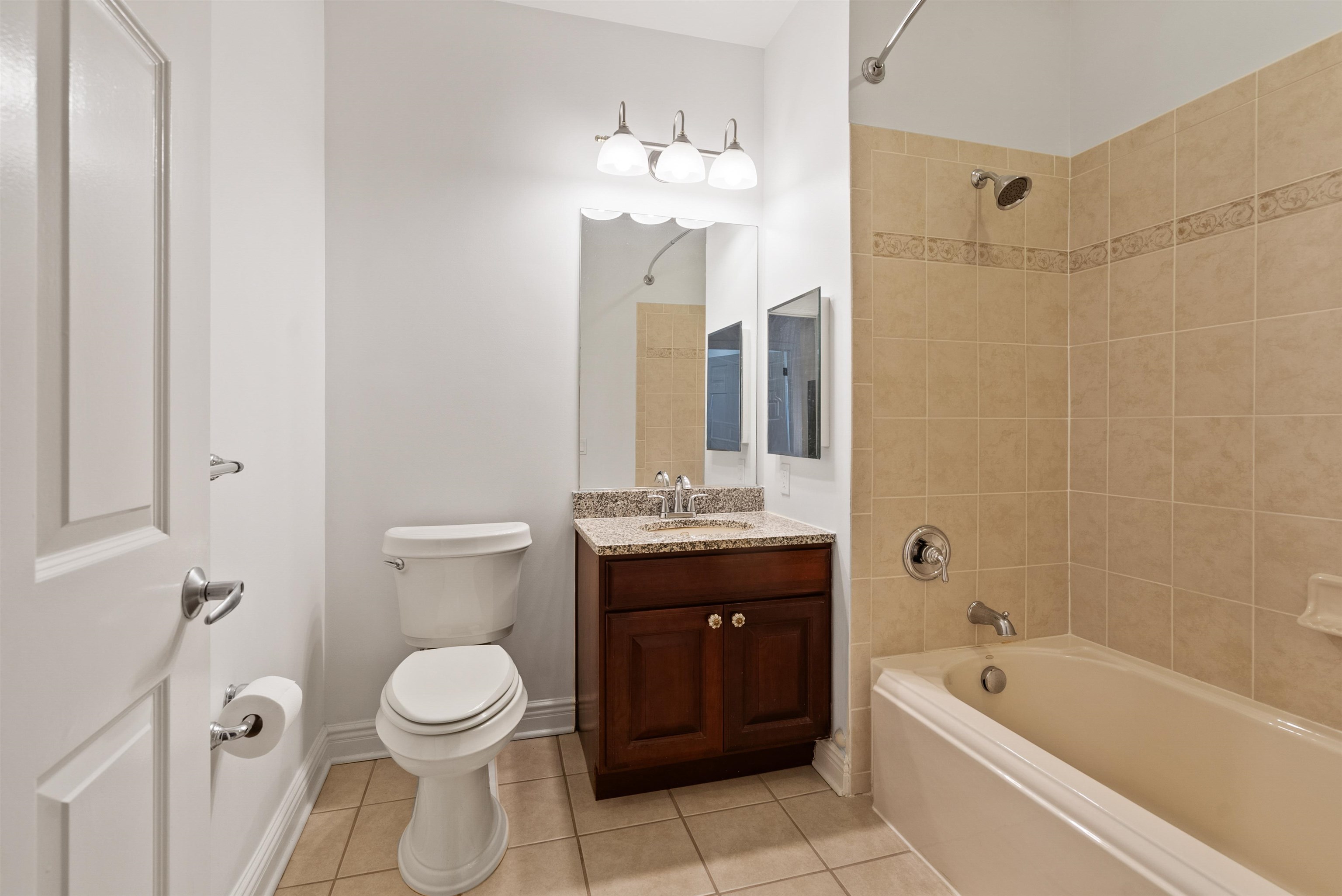 7400 River Road, Unit 317 North Bergen, NJ 07047 - Photo 23 of 41 a bathroom with a bathtub shower sink mirror vanity and a toilet