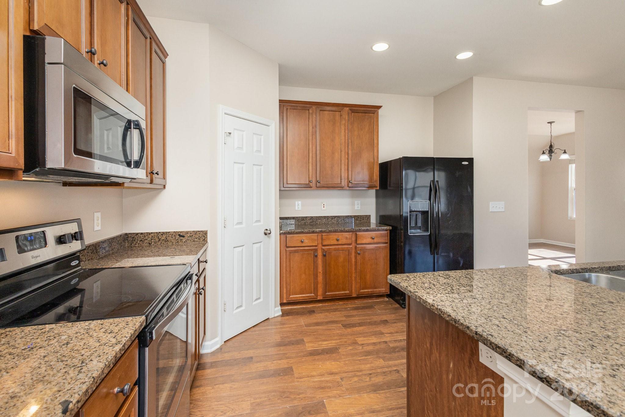1005 Green Terra Road Indian Trail, NC 28079 - Photo 6 of 19 a kitchen with a cabinets sink and stainless steel appliances