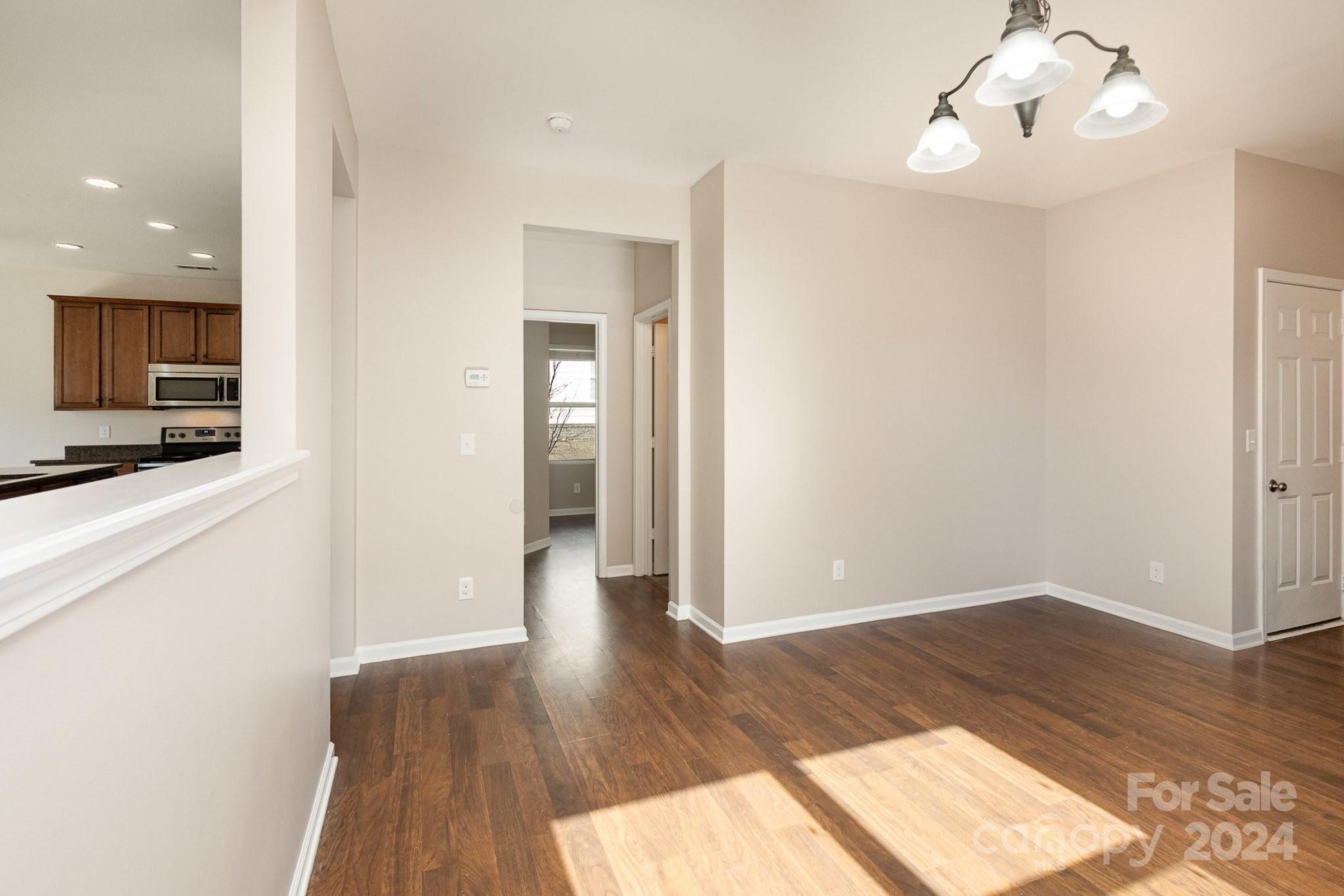 1005 Green Terra Road Indian Trail, NC 28079 - Photo 7 of 19 a view of a kitchen with wooden floor and a kitchen space