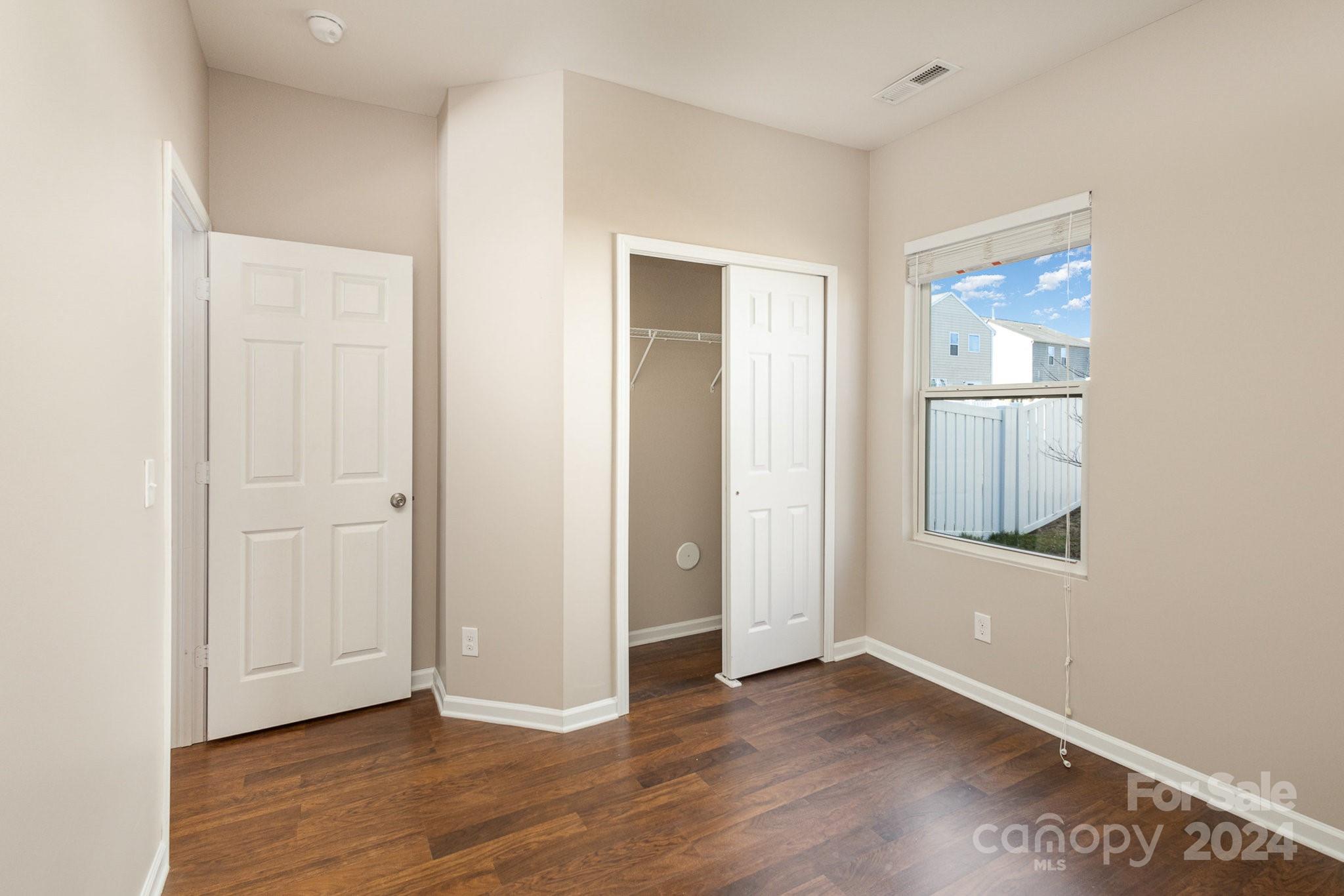 1005 Green Terra Road Indian Trail, NC 28079 - Photo 9 of 19 an empty room with wooden floor and windows