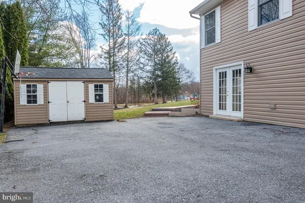 an aerial view of a house with a backyard
