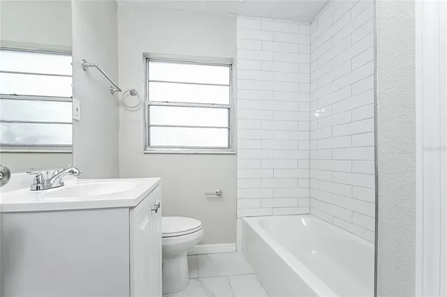 a bathroom with a sink toilet and bathtub