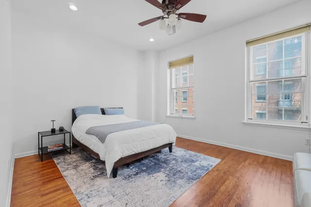 a bedroom with a bed and wooden floor