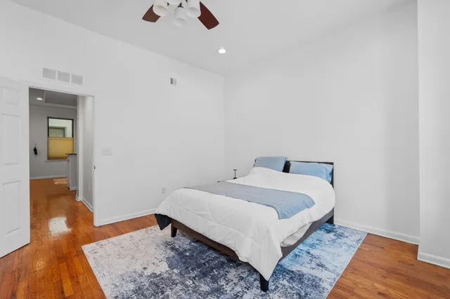 a bedroom with a bed and wooden floor