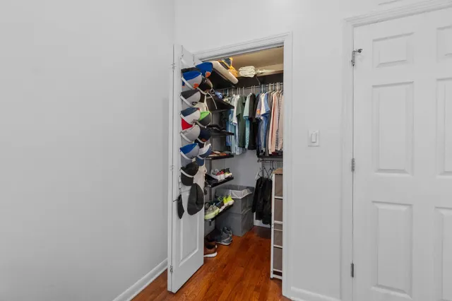 a view of a hallway with closet and a closet