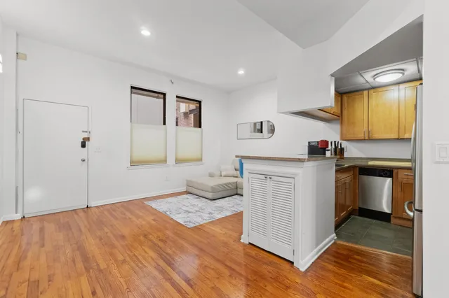 a kitchen with sink cabinets and wooden floor