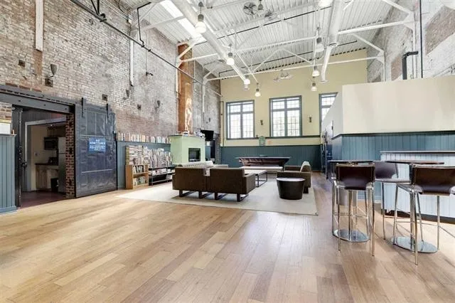 a living room with furniture a rug and a chandelier