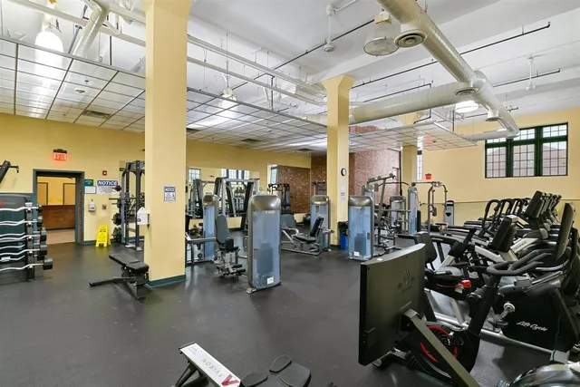 a living room with lots of gym equipment