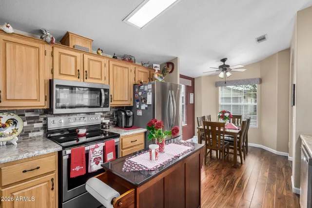 a kitchen with stainless steel appliances a stove a sink dishwasher and cabinets with wooden floor