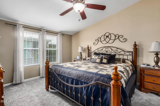 a bed sitting in a bedroom next to a window