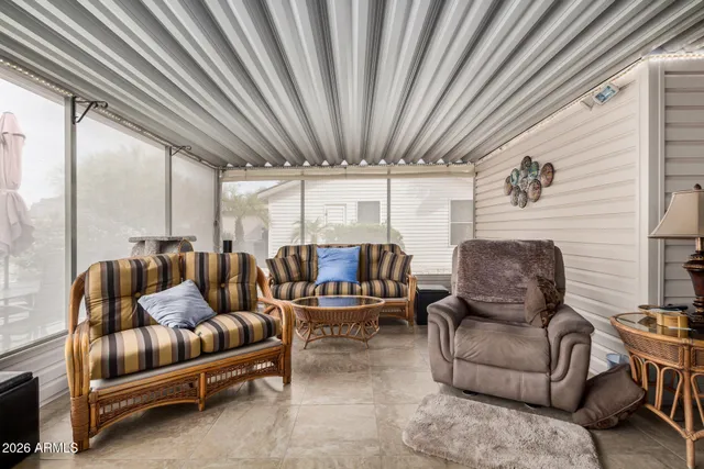 a living room with furniture a ceiling fan and a rug
