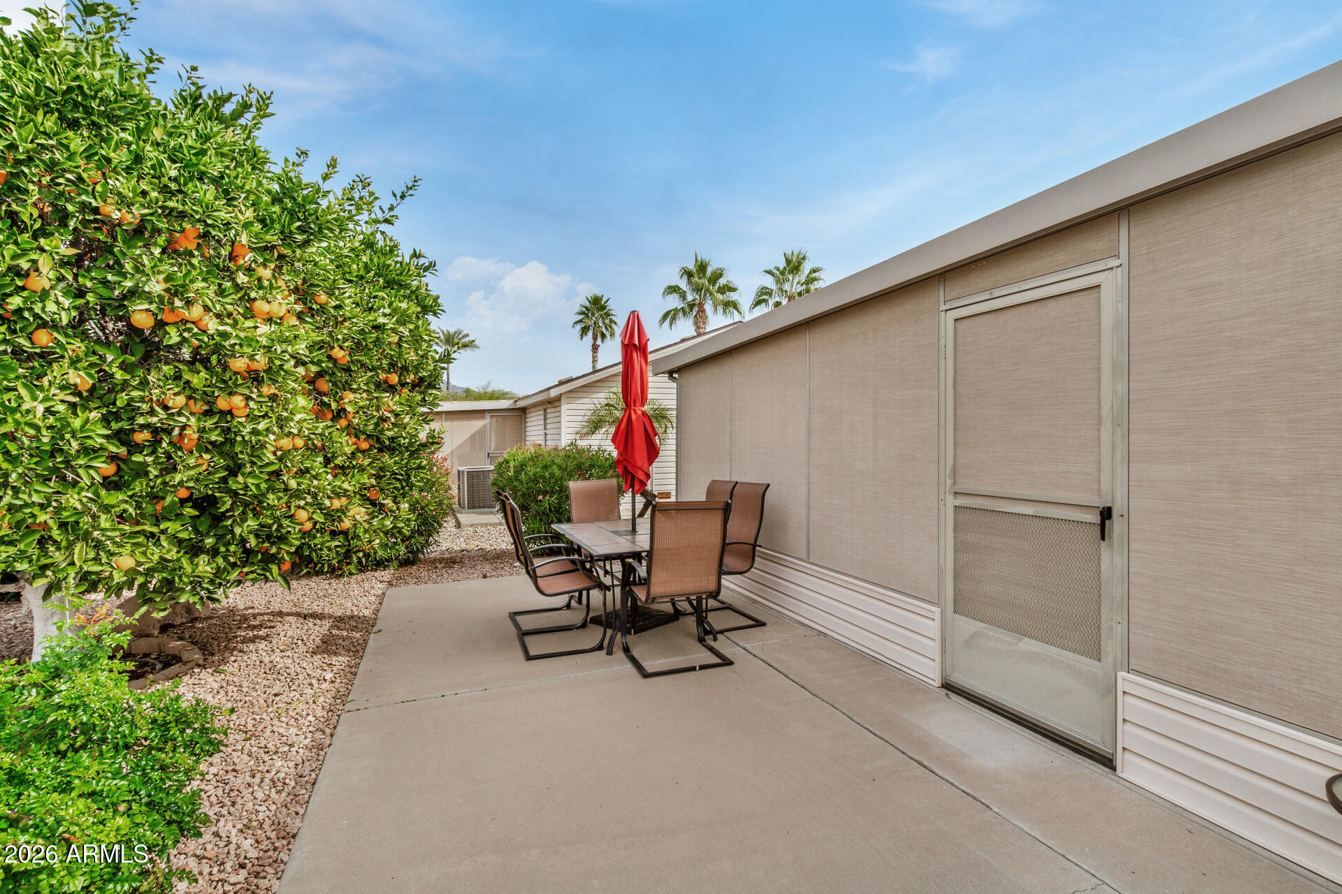 3301 South Goldfield Road, Unit 1006 Apache Junction, AZ 85119 - Photo 29 of 30 a view of a patio with a table and chairs