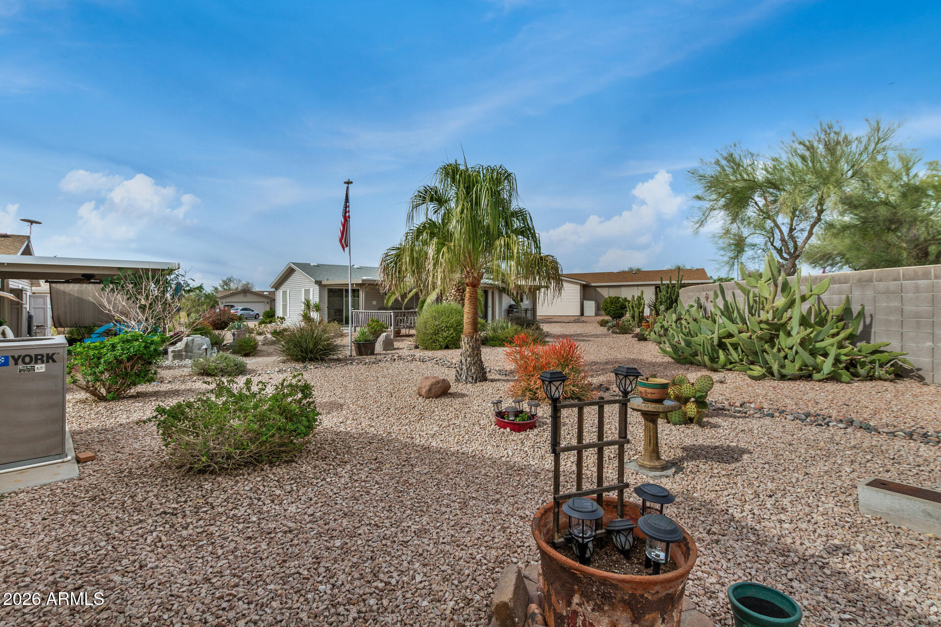 3301 South Goldfield Road, Unit 1006 Apache Junction, AZ 85119 - Photo 30 of 30 a backyard of a house with table and chairs