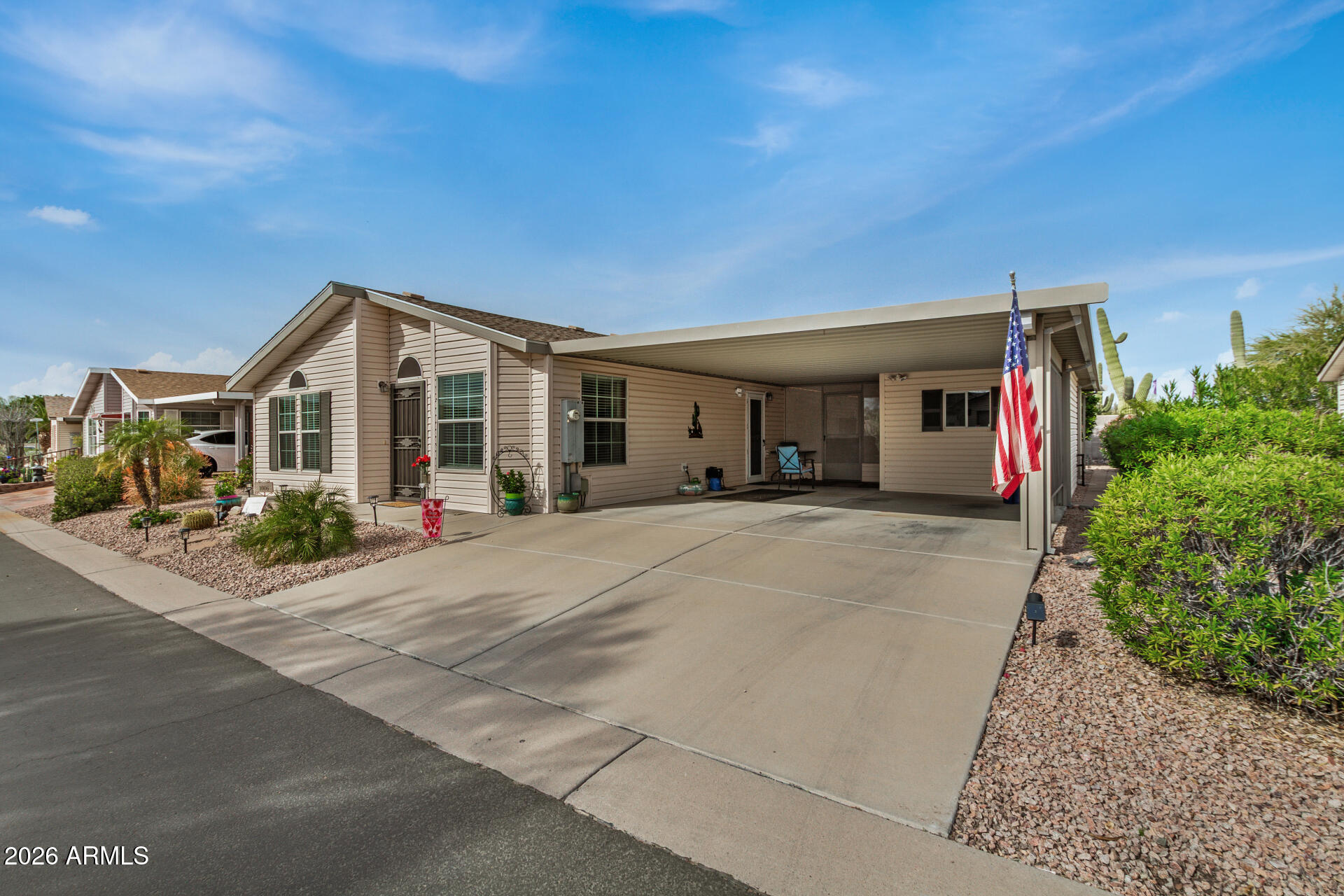 3301 South Goldfield Road, Unit 1006 Apache Junction, AZ 85119 - Photo 5 of 30 a front view of a house with a yard and garage