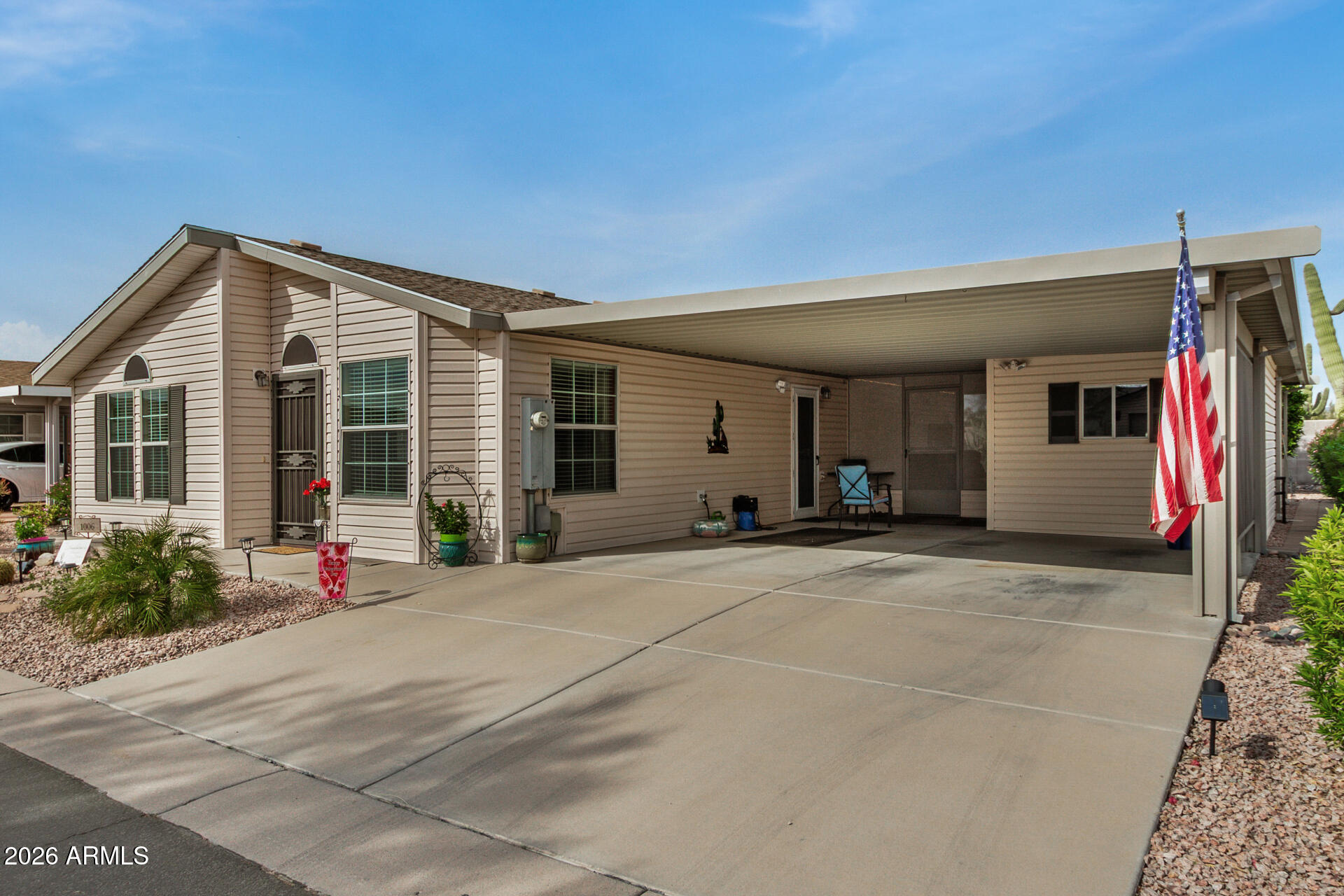 3301 South Goldfield Road, Unit 1006 Apache Junction, AZ 85119 - Photo 6 of 30 a front view of a house with a yard