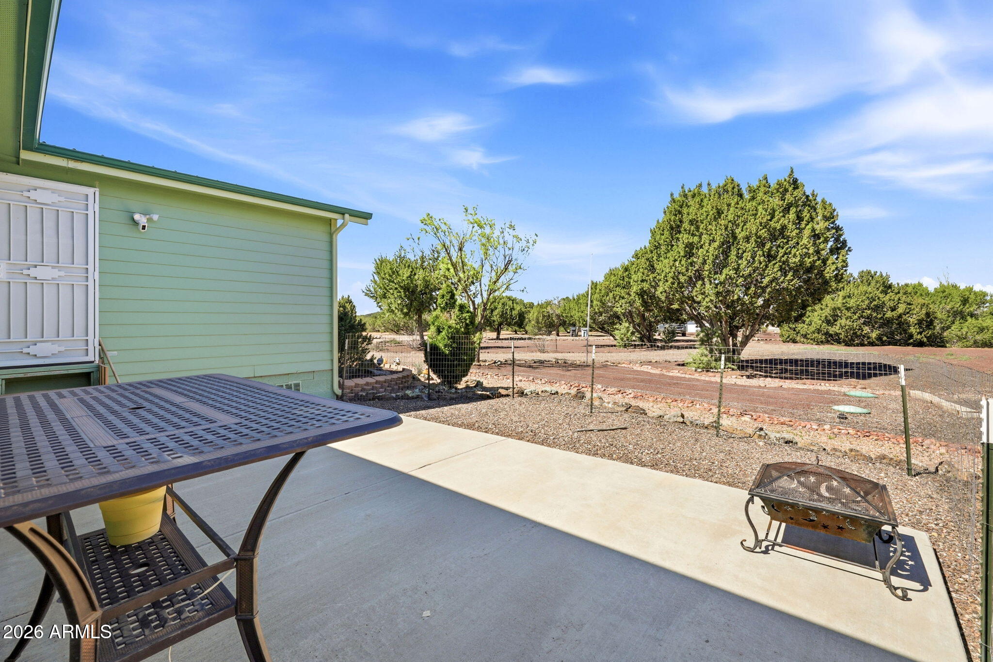6 County Road Concho, AZ 85924 - Photo 26 of 39 a view of a patio with table and chairs with wooden floor and fence