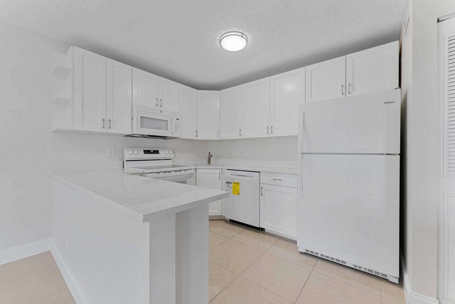 537 Shady Pine Way Greenacres, FL 33415 - Photo 12 of 21 a utility room with cabinets washer and dryer