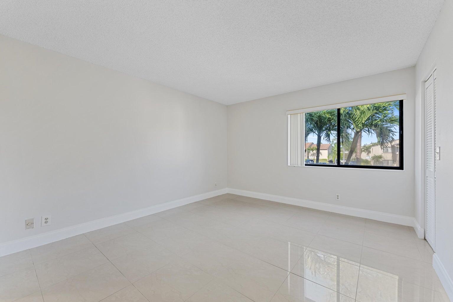 537 Shady Pine Way Greenacres, FL 33415 - Photo 18 of 21 an empty room with windows