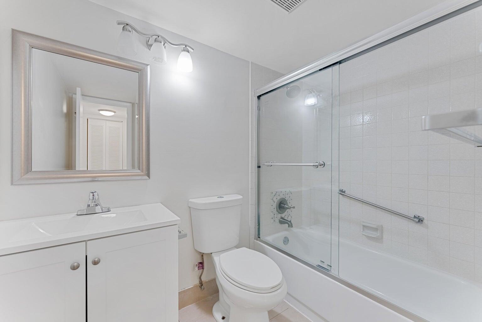 537 Shady Pine Way Greenacres, FL 33415 - Photo 21 of 21 a bathroom with a sink a toilet and shower